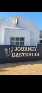 a building with a sign that reads journeyason classifies at Journey Guesthouse in Riversdale