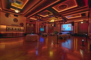a large room with a table and a stage in it at Hotel Edison Times Square in New York