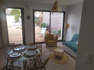 a living room with a table and chairs and a couch at Maison de vacances cosy à La Baule in La Baule