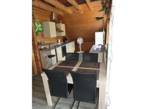 a kitchen and dining room with a table and chairs at Holiday apartment Sterrenbergblick in Oberlenningen