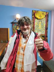 a man giving a thumbs up in a room at STUPA VIEW INN in Kathmandu