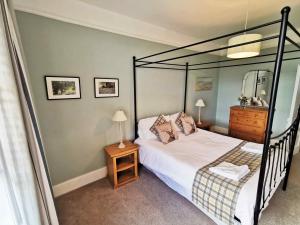 a bedroom with a bed with a black bed frame at Beacon View in Ivinghoe
