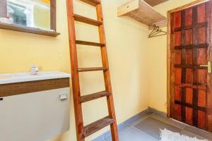 a ladder in a bathroom with a sink and a door at Pousada Oencontro in Rio de Janeiro