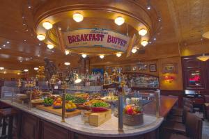 a restaurant with a counter filled with fruits and vegetables at Hotel Edison Times Square in New York