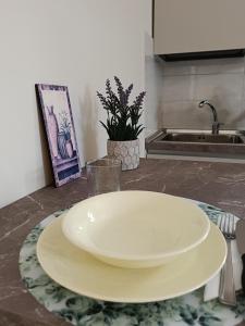 a white plate on a table in a kitchen at il Portichetto in Pescara