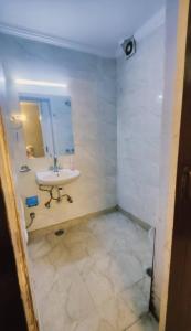 a bathroom with a sink and a mirror at Royal galaxy kalkaj in New Delhi