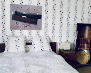 - une chambre avec un lit et une peinture murale dans l'établissement Aux bonheurs des roses, à Valmont