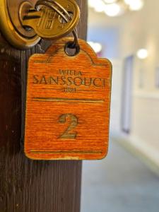 una etiqueta de madera en una puerta con el número en Willa Sanssouci en Kudowa-Zdrój
