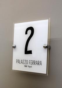 a sign with the number two on a wall at Palazzo Ferrara in Naples