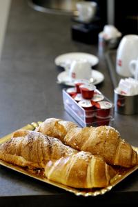 a plate of croissants and strawberries on a table at Palazzo Ferrara in Naples
