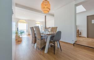a dining room with a table and chairs at Les Pieds Dans L'Eau - Bel appartement - Vue mer in Cancale