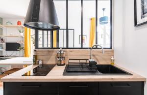 a kitchen counter with a sink and a window at Lucelyne - Beau T2 rénové - Centre - Plage 400m in Dinard