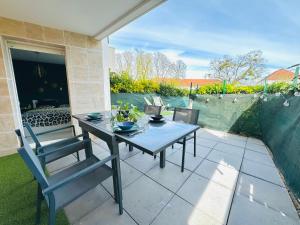 a table and chairs sitting on a patio at Le Nid du Parc in Dijon