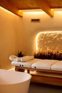 a spa room with three beds and a tub at SKOGUR - Home & Resort in Bukovel