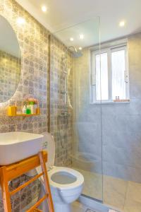 a bathroom with a shower and a toilet and a sink at Marvinas seaside apartments, GAIA apartment & HYDOR jacuzzi apartment in Kremasti +38 photos