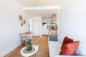 a living room with a couch and a table at Les Pieds Dans L'Eau - Appartment 1 - Vue mer in Cancale