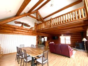 a dining room with a wooden table and chairs at Privacy @ Bras d’Or Lake Eagle House Chalet in St. Peter's