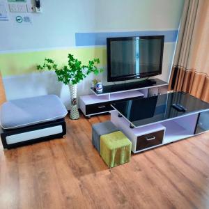 a living room with a flat screen tv and a chair at Littleching vivacity jazz 3 @2bedroom in Kuching +9 photos