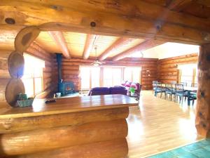 a living room in a log cabin with a bar at Privacy @ Bras d’Or Lake Eagle House Chalet in St. Peter's