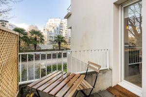 a bench on a balcony with a view of a street at CÔTÉ RIVIÈRE, appartement T2, terrasse & parking in Rennes