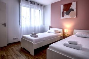 En eller flere senge i et værelse på Le Normand- appartement neuf, 3 chambres, terrasse