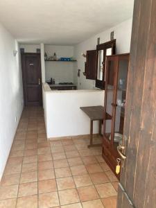 a kitchen with a counter and a table in it at il patio mini appartamento in Pantelleria