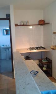 a kitchen with a counter top and a stove at il patio mini appartamento in Pantelleria