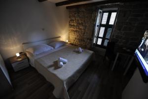 a bedroom with a bed with two towels on it at Top Center in Split