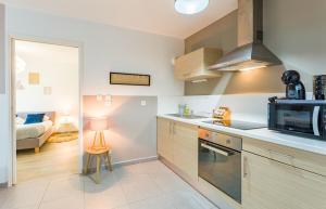 a kitchen with a microwave and a stove top oven at Le Bacchus parking 1 chambre moderne -Tout confort in Rennes