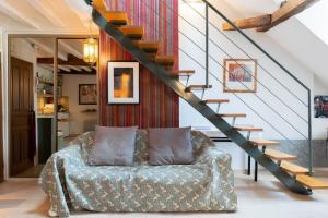 uma sala de estar com um sofá e uma escada em L'Opéra , appartement cosy, centre historique em Rennes