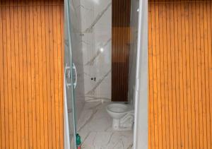 a bathroom with a toilet inside of a bathroom stall at Casa temporada Arembepe Ba in Camaçari