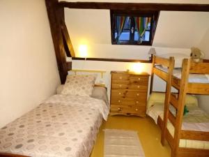 a bedroom with two bunk beds and a dresser at Résidence Maison Mitoyenne - Maison 10 personnes village de GUCHEN MAE-9594 in Guchen +6 photos