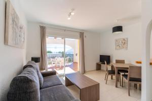 a living room with a couch and a table at Bungalows Imperial Park Unitursa in Calpe