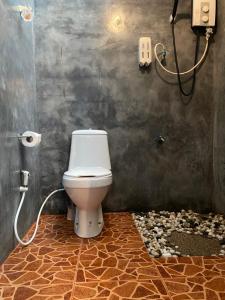 a bathroom with a toilet and a rock floor at Shaya Resort in Pai +61 photos