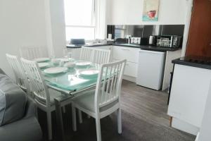 a kitchen with a table and chairs and a kitchen with a table and chairsktop at Farina No8, 3 bedroom Sea view apartment sleeping 7 guests in Bridlington