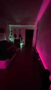 a dark room with pink lights in a room at Parkside Modern Haven - Spacious & Serene in Košice in Košice