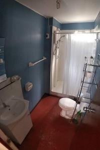 a bathroom with a toilet and a shower and a sink at Vivienda familiar Doña Marta Churin in Churín