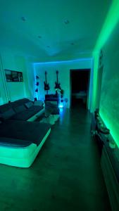 a room with four beds in a room with green lights at Parkside Modern Haven - Spacious & Serene in Košice in Košice