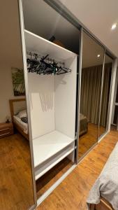 a white cabinet with glass doors in a room at Parkside Modern Haven - Spacious & Serene in Košice in Košice