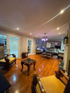 a large living room with a couch and a table at 4 Bedroom House in Mississauga in Mississauga