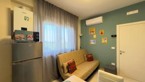 Habitación pequeña con silla y nevera. en Casa Allegra en Chioggia