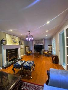 a living room with a couch and a fireplace at 4 Bedroom House in Mississauga in Mississauga