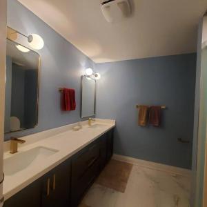 a bathroom with a sink and a mirror at 4 Bedroom House in Mississauga in Mississauga