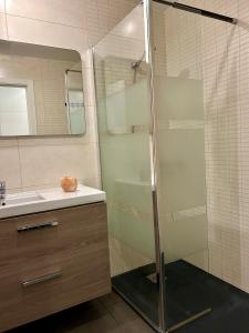 a glass shower in a bathroom with a sink at Fuerte Confort in La Oliva
