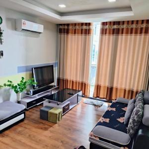 a living room with a couch and a tv at Littleching vivacity jazz 3 @2bedroom in Kuching