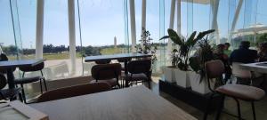 a restaurant with tables and chairs and a large window at Relax & Play Panoramic Golf Vinaroz, Sant Jordi Apartment in Vinaròs