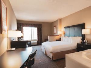 a hotel room with a bed and a desk at Wildwood Lodge in Pewaukee