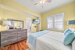 a bedroom with a bed and a ceiling fan at Pelicans Place - 117A in Siesta Key