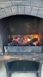 a fire inside of a brick oven with fire at La Casa Garasa in Čačak