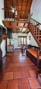 a large room with a bed and a staircase at Casa de Piedra in Termas del Daymán